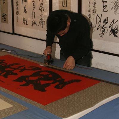 Adding some keyline tape to the edges of the wall scroll