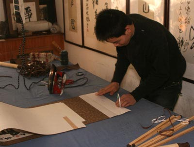 Preparing to add the wooden wall scroll roller