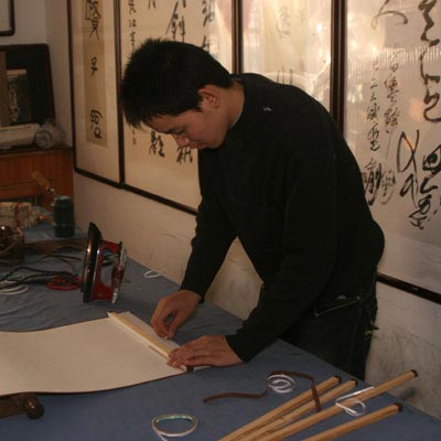 Adding the top frame to the wall scroll